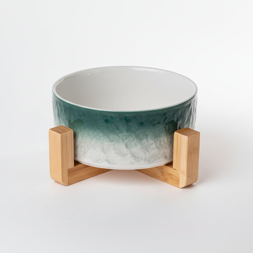 Gamelle pour chat en porcelaine verte avec support ergonomique en bois naturel, design minimaliste et élégant, Palais Félin Paris.