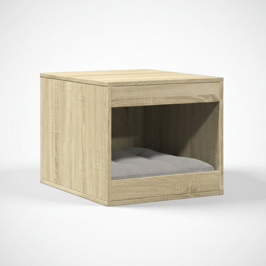 Un meuble pour chat haut de gamme au fini chêne sablé avec un veinage bois naturel, conçu comme cache-litière ou niche pour coussin. L'objet présente un design minimaliste et une fonction anti-odeur, photographié sur un fond neutre pour un rendu luxueux, par Palais Félin Paris.